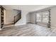 Bright living room featuring sleek flooring, a staircase, and ample natural light at 9605 Elk Mountain Cir, Littleton, CO 80125