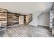 Spacious living room with wood-look floors, accent wall and staircase at 9605 Elk Mountain Cir, Littleton, CO 80125