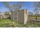 Tan backyard shed with a white door, providing extra storage space at 9605 Elk Mountain Cir, Littleton, CO 80125