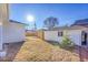 Landscaped backyard featuring a detached garage, new fence, and charming landscaping at 971 S Fillmore Way, Denver, CO 80209