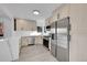 Bright kitchen with stainless steel appliances and quartz countertops at 971 S Fillmore Way, Denver, CO 80209