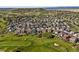Scenic aerial view of a suburban neighborhood near a golf course with lush green fairways at 1665 Diamond Head Dr, Castle Rock, CO 80104