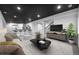 Finished basement showcasing a wet bar, cozy seating, and modern design elements at 1665 Diamond Head Dr, Castle Rock, CO 80104