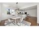 Sun-filled dining room with modern chandelier is adjacent to the kitchen at 1665 Diamond Head Dr, Castle Rock, CO 80104