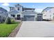 Beautiful two-story home with a three-car garage and landscaped front yard at 1665 Diamond Head Dr, Castle Rock, CO 80104