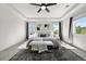 Bright main bedroom with tray ceiling, large windows, and a comfy seating area at 1665 Diamond Head Dr, Castle Rock, CO 80104