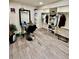 Finished basement with a barber chair, shelving with sneakers and closet space at 4640 W Princeton Ave, Denver, CO 80236