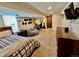 Finished basement featuring a bed, desk, guitar, and television on carpeted floor at 4640 W Princeton Ave, Denver, CO 80236