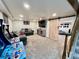 Finished basement with entertainment center, sliding door, and arcade games at 4640 W Princeton Ave, Denver, CO 80236