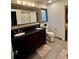 Well-appointed bathroom with a double vanity, tiled floors, and neutral colors at 4640 W Princeton Ave, Denver, CO 80236