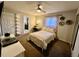 Comfortable bedroom with a ceiling fan, desk, and closet with mirrored doors at 4640 W Princeton Ave, Denver, CO 80236