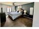 Comfortable bedroom with carpet flooring, a large window, and stylish decor at 4640 W Princeton Ave, Denver, CO 80236