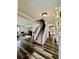 Inviting foyer featuring wood floors, a staircase, and views into the living and dining areas at 4640 W Princeton Ave, Denver, CO 80236