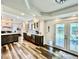 Bright kitchen featuring modern appliances, a farmhouse sink, and access to the backyard at 4640 W Princeton Ave, Denver, CO 80236