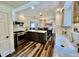 Bright kitchen with white cabinets, stainless steel appliances, and a farmhouse sink at 4640 W Princeton Ave, Denver, CO 80236