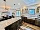 Elegant kitchen with a large island, marble countertops, stainless steel appliances, and a modern chandelier at 4640 W Princeton Ave, Denver, CO 80236