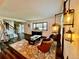 Cozy living room with wood floors, a large window, comfortable seating, and stylish light fixtures at 4640 W Princeton Ave, Denver, CO 80236