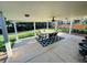 Covered patio with dining table and chairs and a ceiling fan on a sunny day at 4640 W Princeton Ave, Denver, CO 80236