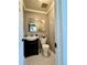 Cozy powder room featuring a modern vanity, decorative mirror, patterned tile floor and updated fixtures at 4640 W Princeton Ave, Denver, CO 80236