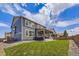 Spacious backyard with lush green lawn, patio, and well-maintained fence and landscaping at 10991 Xanadu St, Commerce City, CO 80022