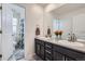 Bathroom showcasing a double vanity with brushed nickel faucets, and a view of a shower-tub combination at 10991 Xanadu St, Commerce City, CO 80022