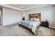 The main bedroom has carpet, a decorative headboard and an ensuite bath at 10991 Xanadu St, Commerce City, CO 80022