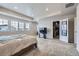 This carpeted main bedroom features multiple windows and walk-in closet at 10991 Xanadu St, Commerce City, CO 80022
