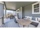 Inviting covered patio featuring comfortable seating, a patio table, and string lights at 10991 Xanadu St, Commerce City, CO 80022