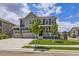 Beautiful two-story home with well-maintained lawn, mature trees, and a three-car garage at 10991 Xanadu St, Commerce City, CO 80022
