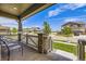 Inviting front porch with comfortable seating and views of the manicured neighborhood at 10991 Xanadu St, Commerce City, CO 80022