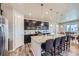 A well-equipped kitchen with a central island, bar stools, and ample cabinet space at 10991 Xanadu St, Commerce City, CO 80022