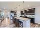 Spacious kitchen boasts a large island with bar seating, stainless appliances, and modern fixtures at 10991 Xanadu St, Commerce City, CO 80022