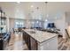 A modern kitchen with a large island featuring a granite countertop and stainless steel appliances at 10991 Xanadu St, Commerce City, CO 80022
