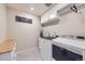 Functional laundry room with a modern washer and dryer, countertop, and convenient upper cabinets at 10991 Xanadu St, Commerce City, CO 80022