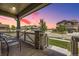 Inviting covered porch with seating, offering scenic neighborhood views and a relaxed ambiance at 10991 Xanadu St, Commerce City, CO 80022