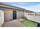 This backyard features a door, a wooden deck, small green turf, and is surrounded by a white fence at 4357 W 118Th Pl, Westminster, CO 80031