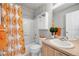 Cheerful bathroom with a shower-tub combo, stylish vanity, and bright orange accents at 4357 W 118Th Pl, Westminster, CO 80031