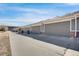 This photo shows a row of garages with gray doors on a sunny day at 4357 W 118Th Pl, Westminster, CO 80031