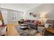 Inviting living area featuring hardwood floors, cozy seating, and natural light from large windows at 4357 W 118Th Pl, Westminster, CO 80031
