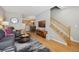 Open-concept living room with hardwood floors, stairway and seamless access to kitchen and dining area at 4357 W 118Th Pl, Westminster, CO 80031