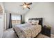 Bright main bedroom with a decorative ceiling fan, a plush bed, and large windows offering scenic views at 4357 W 118Th Pl, Westminster, CO 80031