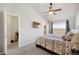 Bright main bedroom featuring a decorative ceiling fan, plush carpeting, and a large window with scenic views at 4357 W 118Th Pl, Westminster, CO 80031