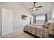 Comfortable main bedroom featuring a decorative ceiling fan, plush carpeting, and a large window with scenic views at 4357 W 118Th Pl, Westminster, CO 80031