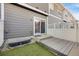 Private outdoor patio with gray wood siding, artificial turf, and white fencing at 4357 W 118Th Pl, Westminster, CO 80031