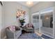 Sitting area with comfortable chairs, vibrant rug, modern art, and a sliding door to a deck at 4357 W 118Th Pl, Westminster, CO 80031