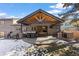 A covered back patio featuring a built-in grill and bar area, comfortable seating, and an outdoor entertainment space at 7233 S Harrison Way, Centennial, CO 80122