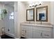 Bright bathroom featuring double vanity, frameless shower, and modern fixtures at 7233 S Harrison Way, Centennial, CO 80122