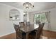 Charming dining area featuring natural light, hardwood floors, and an elegant chandelier at 7233 S Harrison Way, Centennial, CO 80122