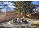 Outdoor fire pit with surrounding chairs, perfect for gatherings and enjoying cozy evenings in the backyard at 7233 S Harrison Way, Centennial, CO 80122