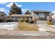 Charming home with a well-manicured lawn, landscaping, and a two-car garage, showcasing its curb appeal at 7233 S Harrison Way, Centennial, CO 80122